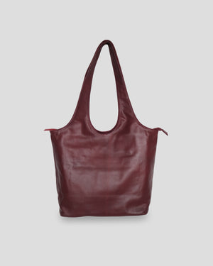 A maroon Ani Bag from bali with a smooth texture, featuring a shoulder strap