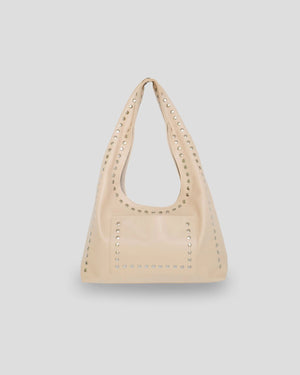 Beige handbag with studded details on a light gray background