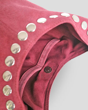 Close-up of a pink leather product with silver studs on a white background