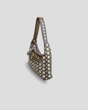 Studded handbag on a light gray background