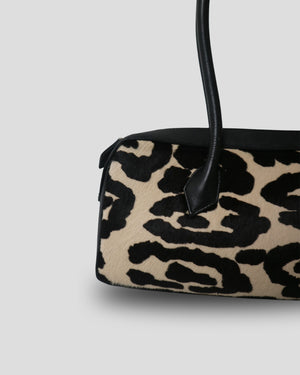 Top angle view of Cila genuine leather handbag Noir Bloom – double top handles and cow print detail