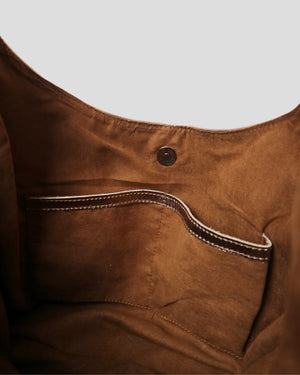 Spacious interior of Kaia Plain genuine leather handbag in camel – suede lining with open pockets