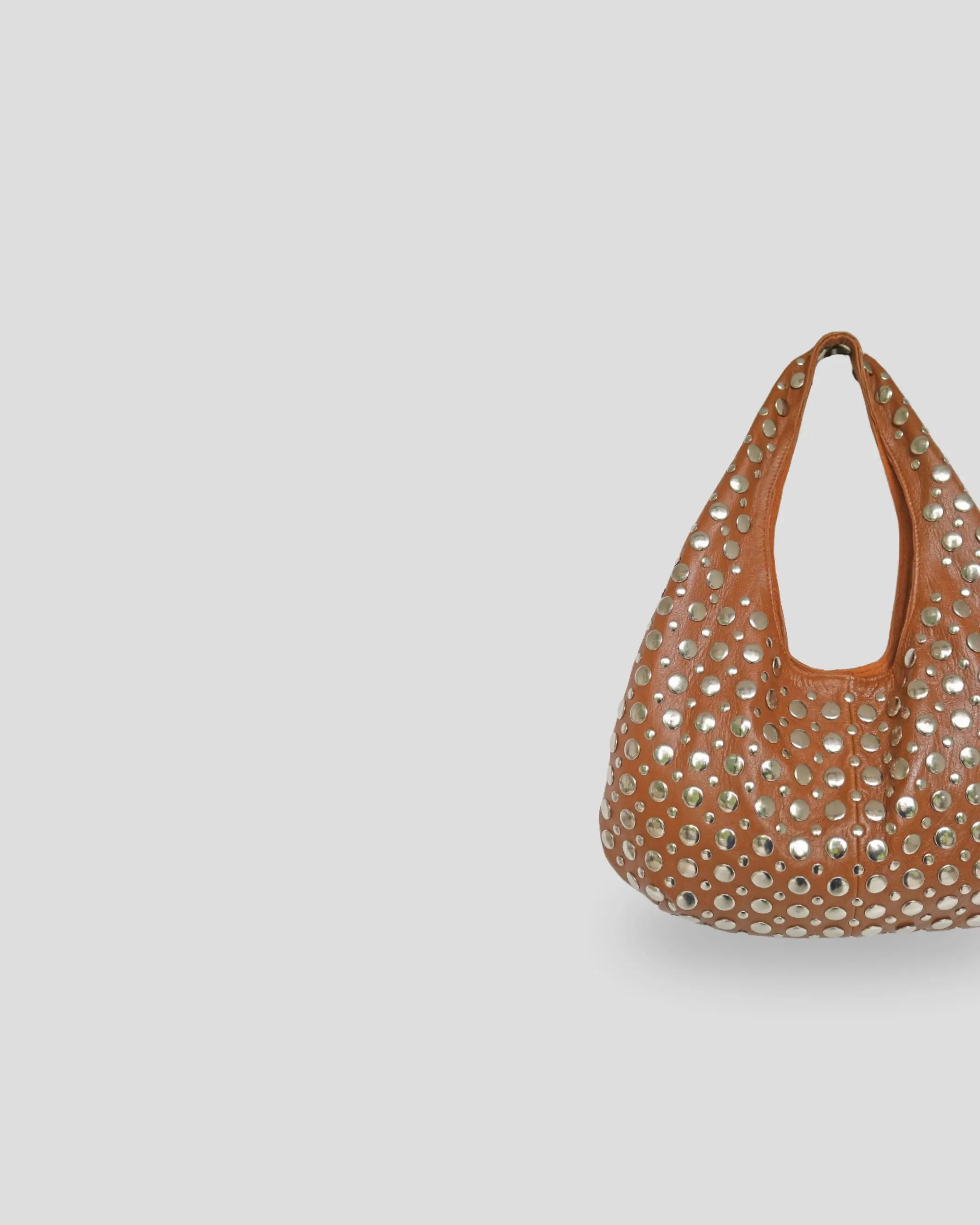 Side angle of handmade studded leather shoulder bag in paris