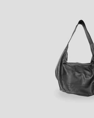 Black leather handbag on a light gray background
