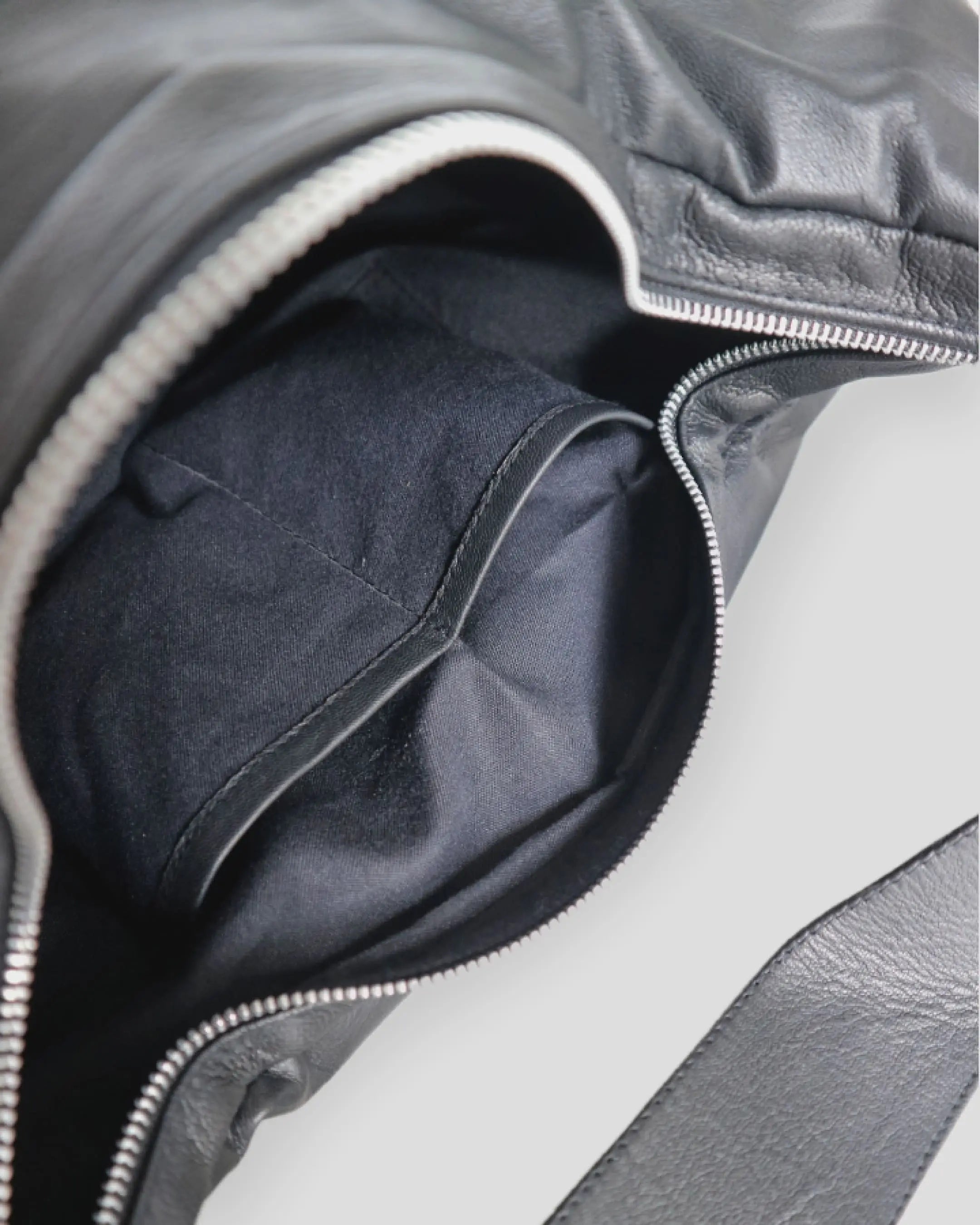 Interior view of women's shoulder bag showing pocket and suede lining details