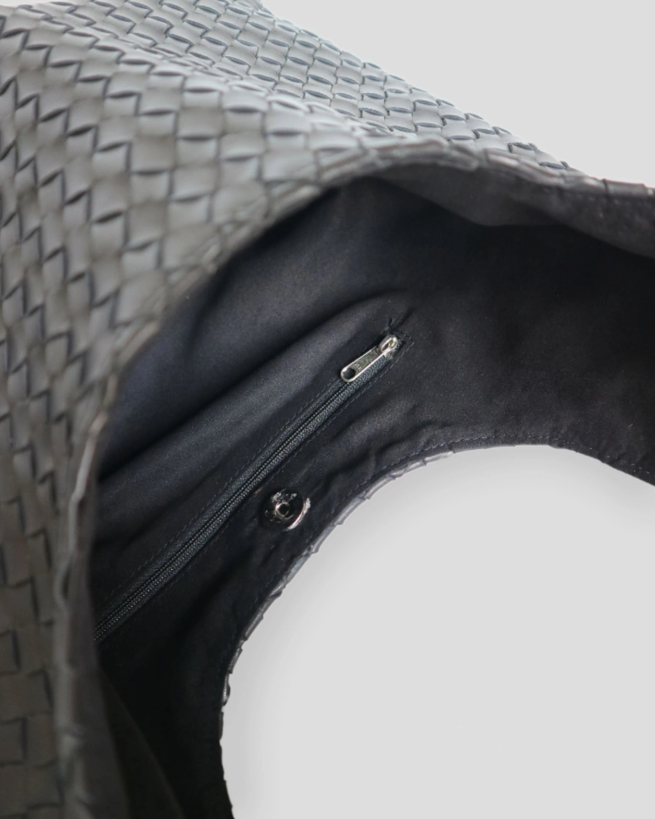 Black woven leather shoulder bag for women with textured pattern and zipper pocket - Bulvara handmade bag